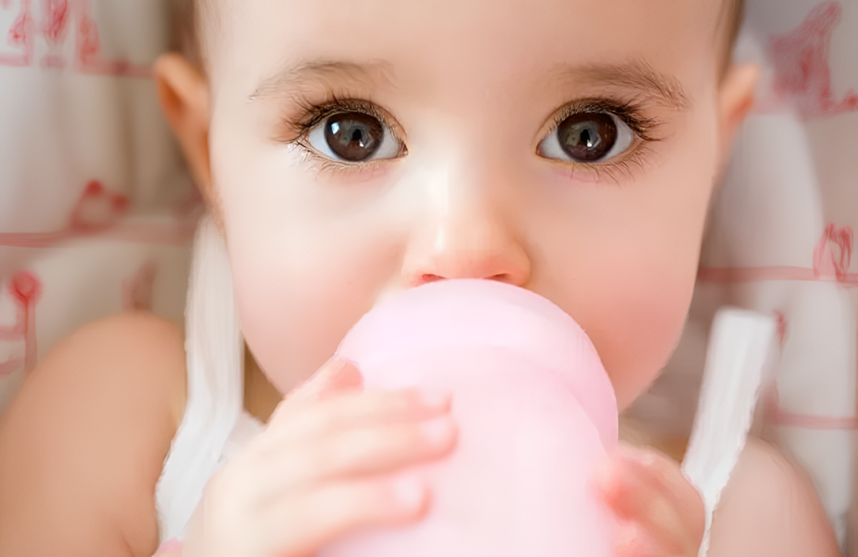 Baby bottle warmer with included sponge brush for easy cleaning
